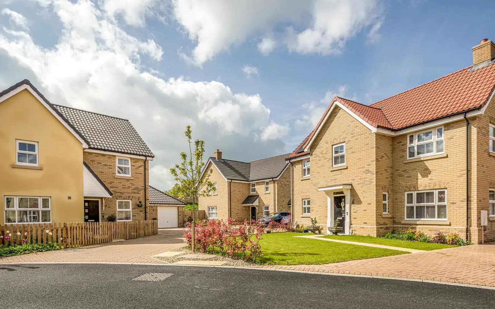 New homes by Orbit Homes around a green